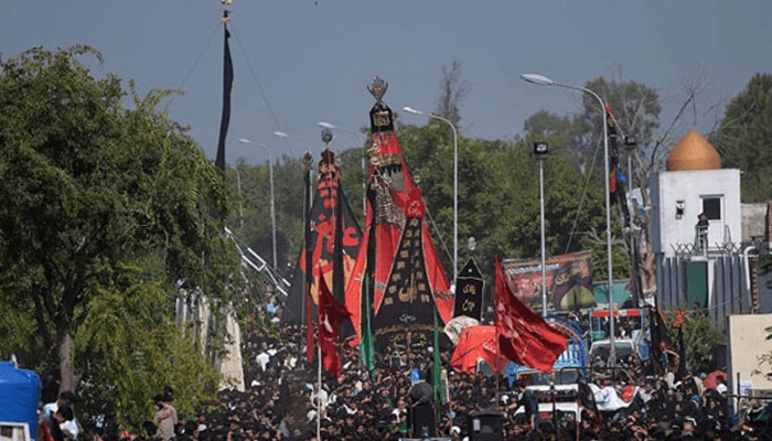 Participants attending the central 9th Muharram gathering at Nishtar Park in Karachi under strict security arrangements.