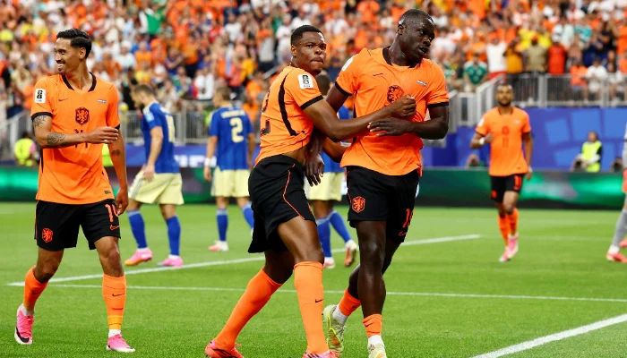 Dutch football players celebrating after defeating Sweden 5-1 in a World Cup Group F match in Houston Stadium.