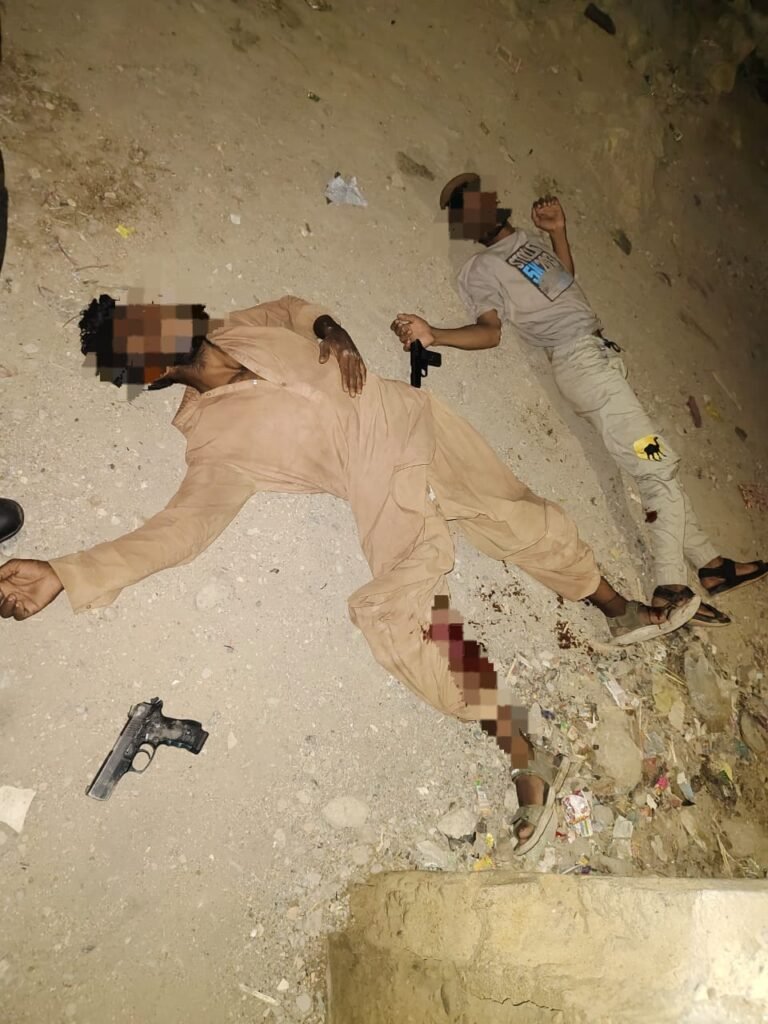 Police officers at the scene of an encounter in New Karachi where two suspects were arrested