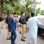 Police officials inspecting security deployment at Imam Bargahs during Muharram in Karachi.