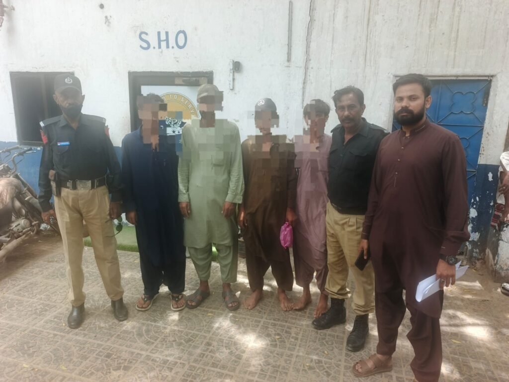 Malir Police officers transfer detained Afghan nationals to a holding center in Karachi