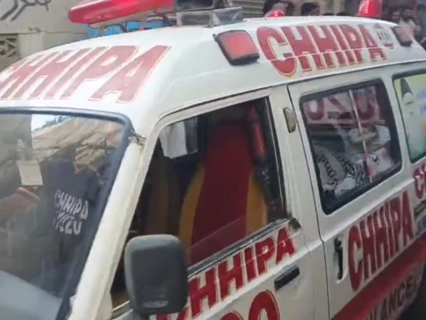 Police inspect a truck involved in a fatal road accident on Karachi's Super Highway that killed three motorcyclists.