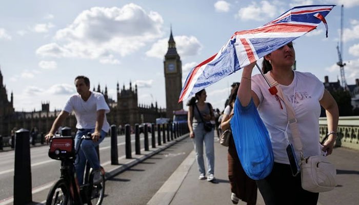 People seek shade during an intense heatwave as the UK records one of its hottest Junes on record.