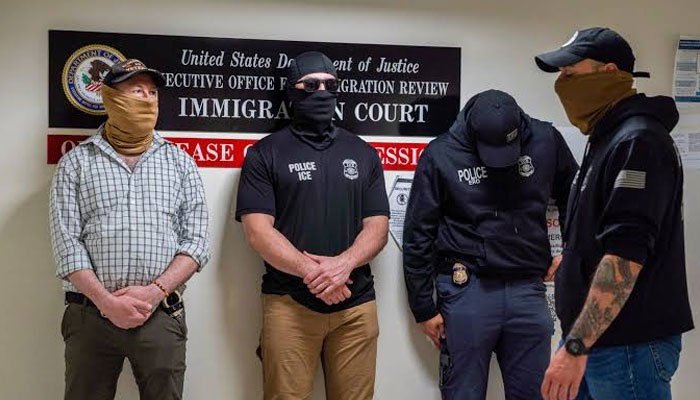 US Immigration and Customs Enforcement officers during an immigration enforcement operation.