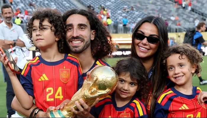 Spain footballer Marc Cucurella, known for his long curly hair, during a FIFA World Cup celebration.