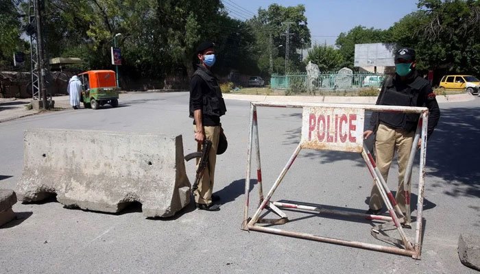 Security personnel at the scene after a police van came under attack in Dera Ismail Khan, Pakistan.