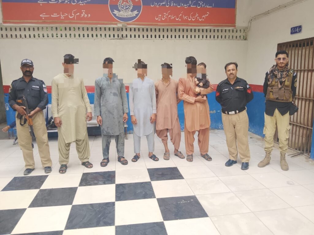 Karachi police escort undocumented Afghan nationals during an operation in Qaidabad.