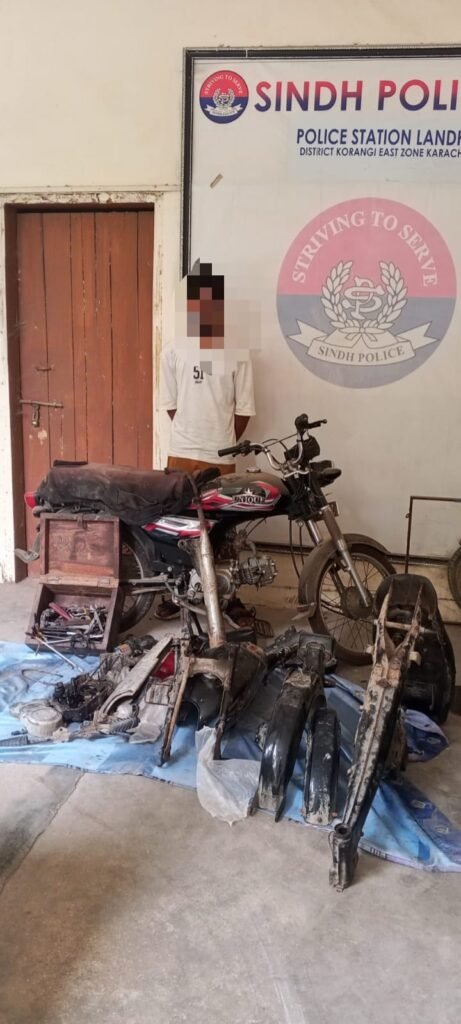 Recovered stolen motorcycle and spare parts seized by Landhi Police in Karachi.