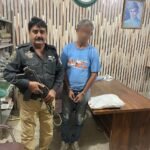 Police officers with recovered gutka mawa packets after arresting a suspect in Karachi's Shah Faisal Colony.