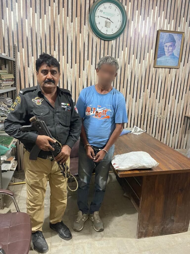 Police officers with recovered gutka mawa packets after arresting a suspect in Karachi's Shah Faisal Colony.