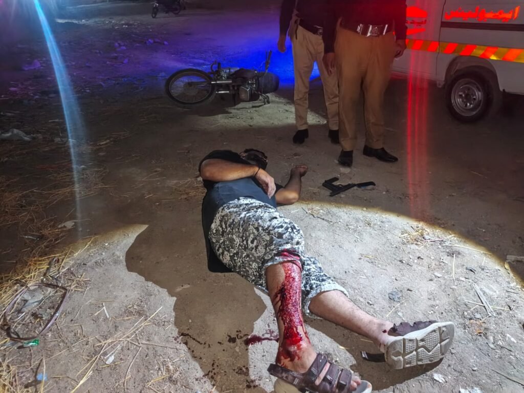 Police officials in Karachi after arresting an alleged robbery suspect during a reported encounter in Saeedabad.