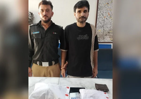East District Police officials with seized narcotics after arresting a suspected drug trafficker in Karachi's Jamshed Quarters.