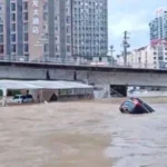 Rescue teams evacuate residents from flooded neighborhoods in southern China after heavy rainfall.