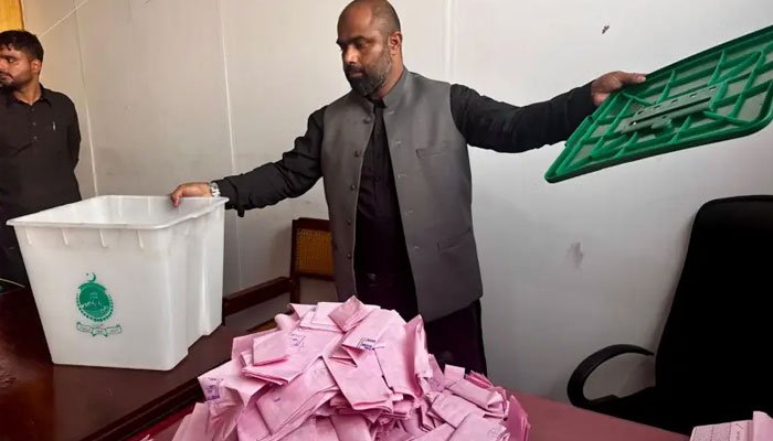 Polling staff counting ballots during the second phase of the Azad Kashmir Legislative Assembly elections.