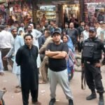 Authorities remove illegal encroachments during a crackdown at Bolton Market in Karachi.