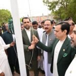Karachi Water Corporation CEO Ahmed Ali Siddiqui hoists the national flag at an Independence Day ceremony