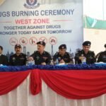 Karachi police officials attend a drug disposal ceremony in Surjani Town