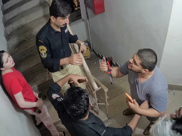 Police officers investigating a viral women’s fight incident in Defence Karachi