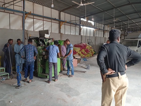 RTO Karachi officials conduct a raid at an illegal cigarette factory and seize machinery and tobacco products.