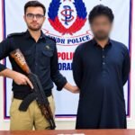 Korangi Police officers with recovered gutka mawa packets after an arrest in Karachi