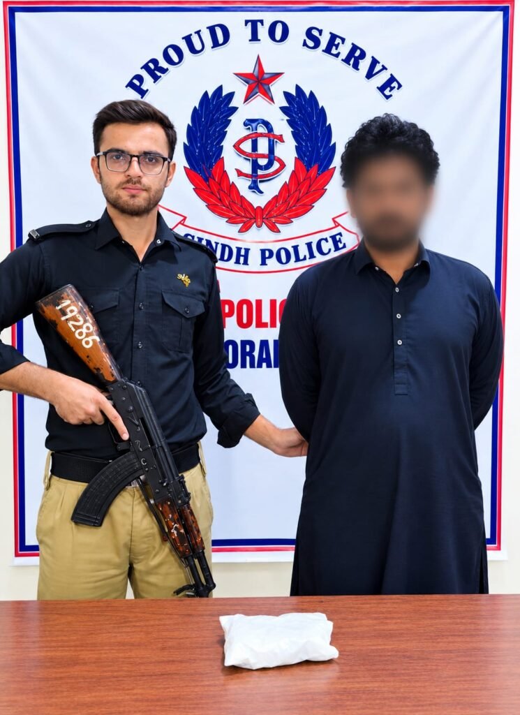 Korangi Police officers with recovered gutka mawa packets after an arrest in Karachi