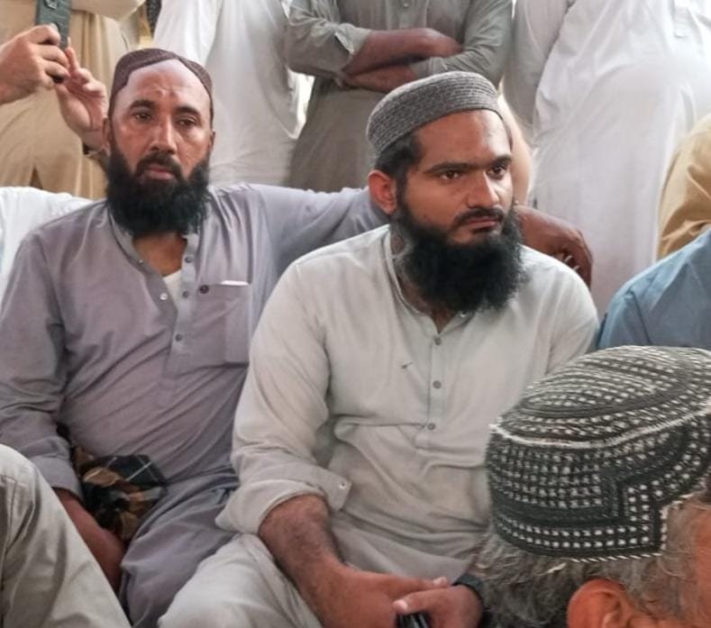 Sardar Muhammad Farooq Gujjar meeting the father of Hafiz Rosham after the Manghopir robbery incident.