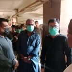 Police investigate a flat in Ahsanabad Karachi after five bodies were discovered