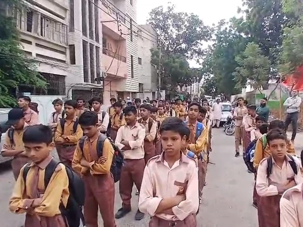 Students and teachers protesting outside Delhi Government Boys School in Karachi after four days of closure.