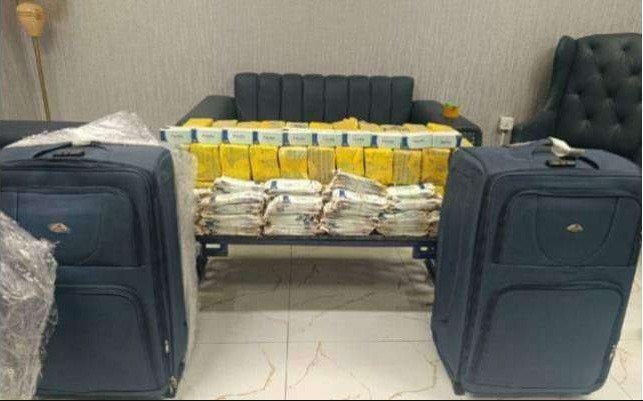 Customs officials seize suspected illegal medicines from a passenger arriving at Karachi Airport.