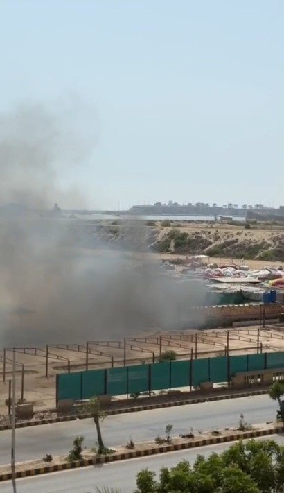 Rescue teams responding to a fire at Sunday Bazaar shops in Clifton Karachi