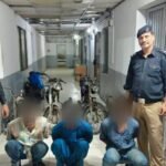 Karachi police display a recovered motorcycle, engines, chassis and other parts following the arrest of three suspected motorcycle thieves