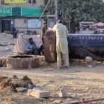 Water Corporation repair work on a damaged 33-inch water pipeline near Urdu College, with possible water supply disruptions in Gulshan-e-Iqbal, Karachi.