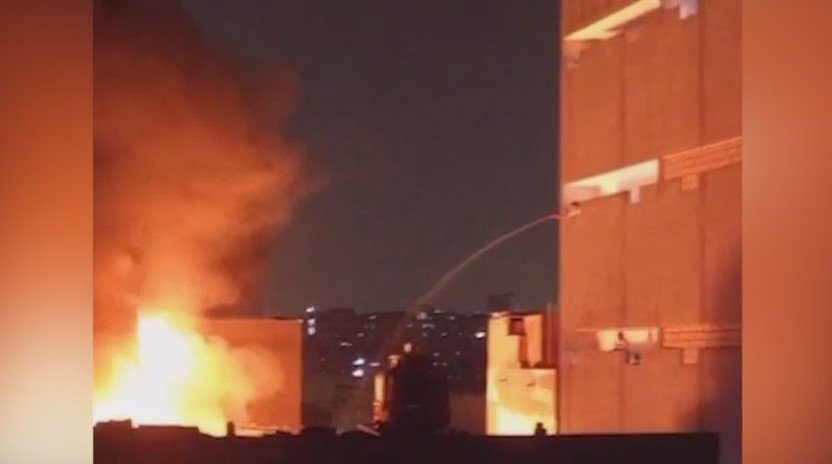Sindh Rangers personnel assisting rescue teams at a factory fire in Azizabad Karachi