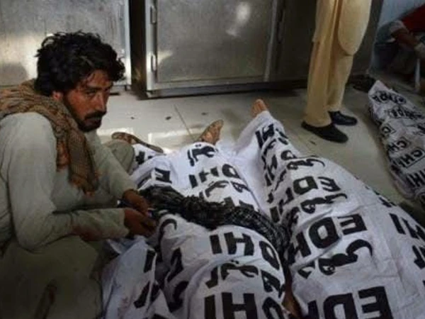 Police and crime scene unit investigate the deaths of an elderly couple in North Karachi