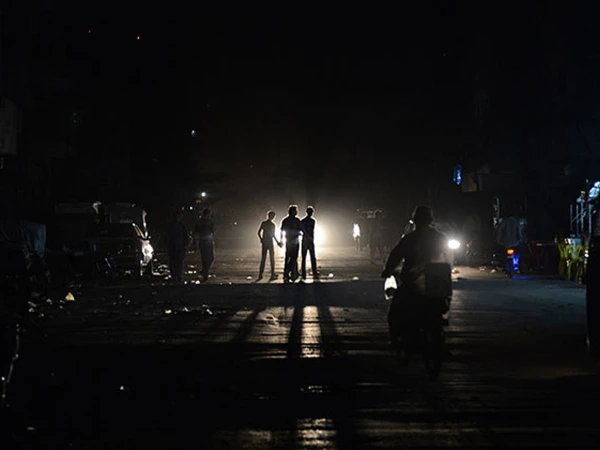 Residents block a road in Azizabad, Karachi, during a protest against a prolonged power outage.