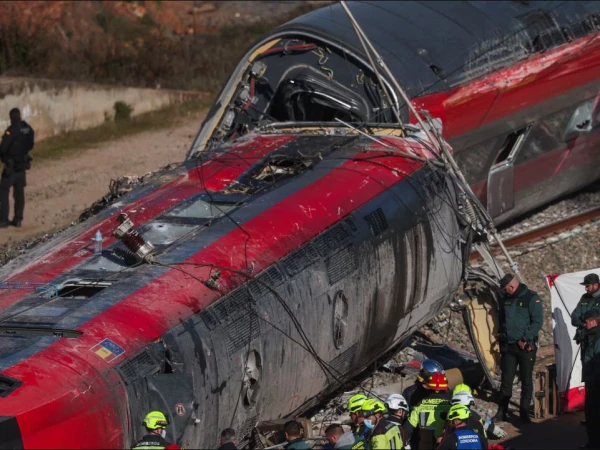 Train Accident in Spain involving two high-speed trains, with derailed carriages and debris near the railway line.