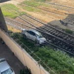 Damaged car involved in a collision with a freight train engine near Netty Jetty Bridge in Karachi.