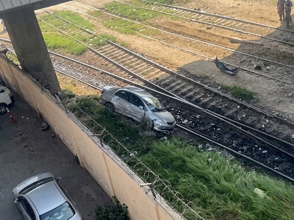 Damaged car involved in a collision with a freight train engine near Netty Jetty Bridge in Karachi.