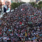 Participants holding Palestinian flags during Gaza solidarity march in Karachi
